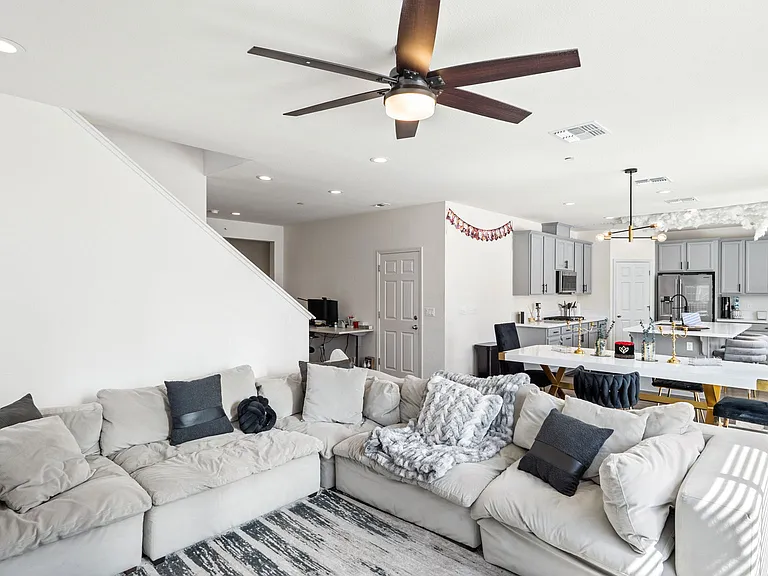 open-concept layout with a spacious great room, elegant electric fireplace, and large windows that fill the home with natural light