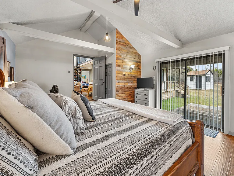 Primary bedroom with door to back patio/deck