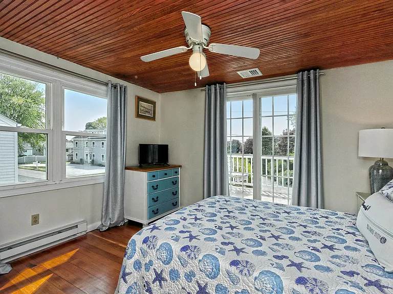 Bedroom with sliders which lead to upper deck with water views.