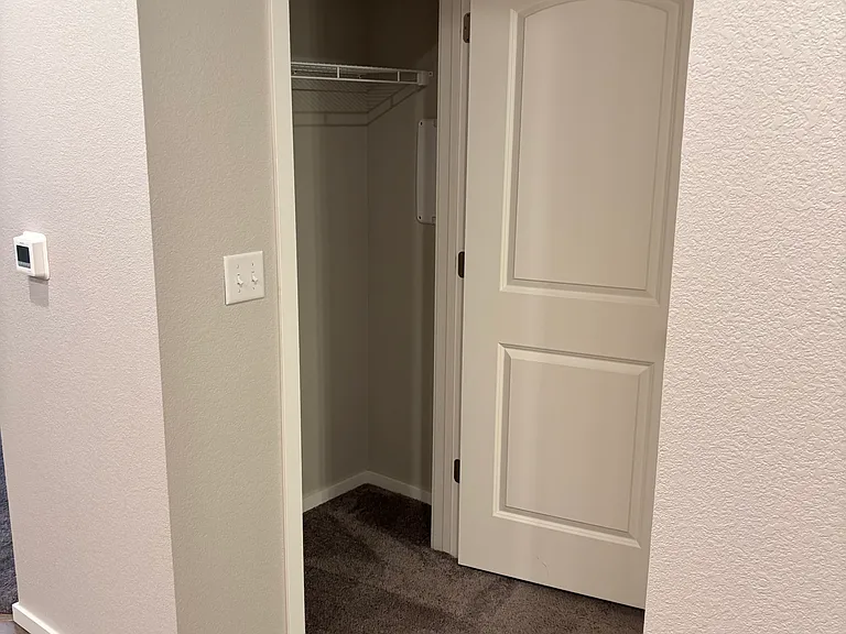 Good sized coat closet off of the kitchen leading to the bathroom and bedroom