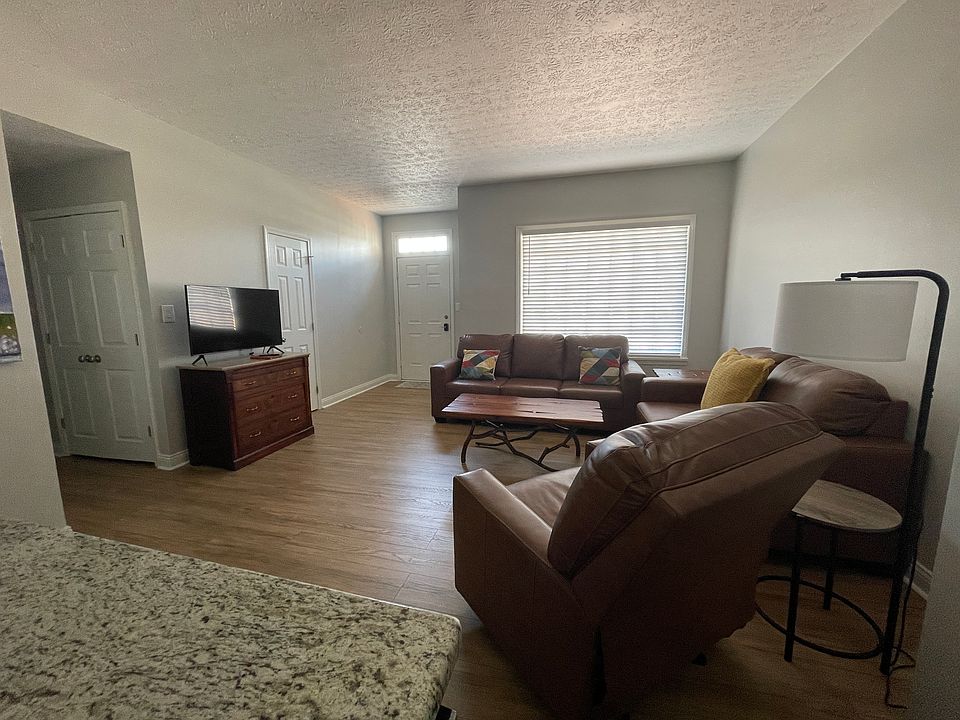 The living area has plenty of leather seating.