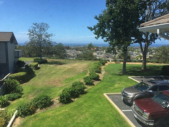 Upstairs view of back patio and parking