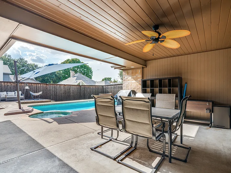 Covered patio with fan and shade to enjoy your backyard.