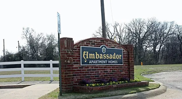 Ambassador Apartments community monument sign at the property entrance