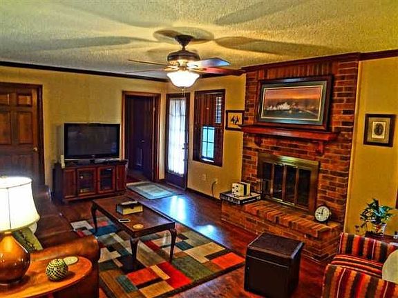 Spacious living room with plenty of space and brick, gas fireplace.