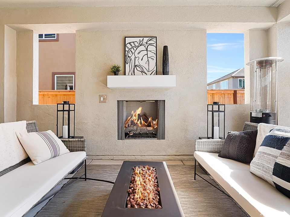 California room with fireplace that leads to covered gazebo for more covered backyard entertaining.
