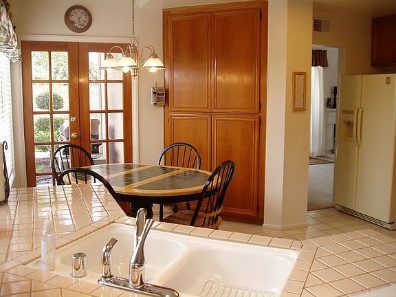 Large, open kitchen with french doors leading out to back and side yards
