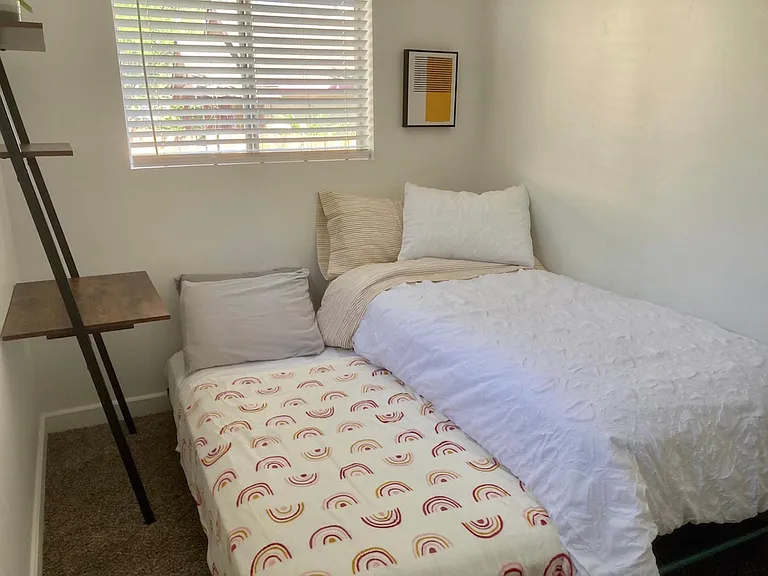 Guest room with trundle bed and private workspace.