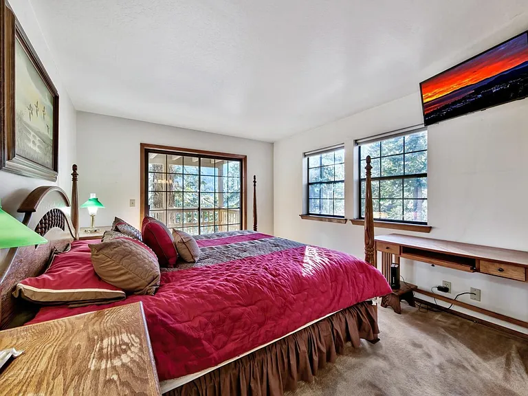 Master Bedroom with mid-level wrap around deck access and king bed.