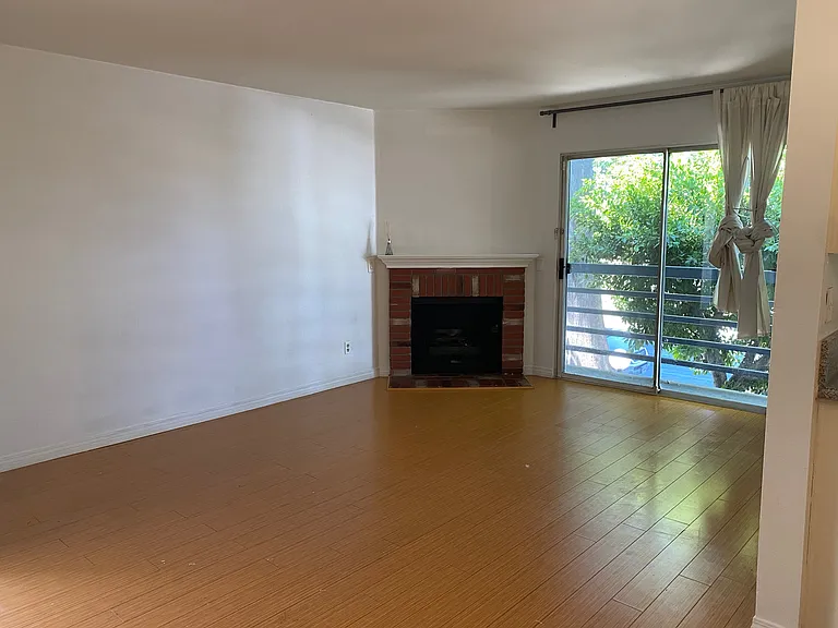 Living room with fireplace leading out to balcony