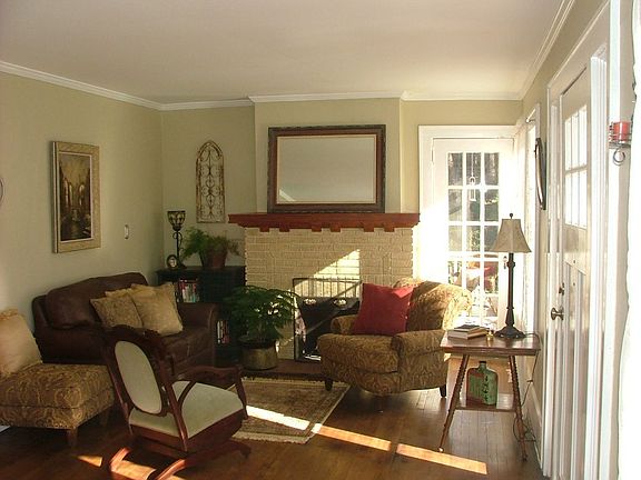 Large Living space with Hardwood Floors and Crown Molding