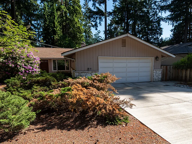 Spacious two car garage with a new driveway on a quiet lane.