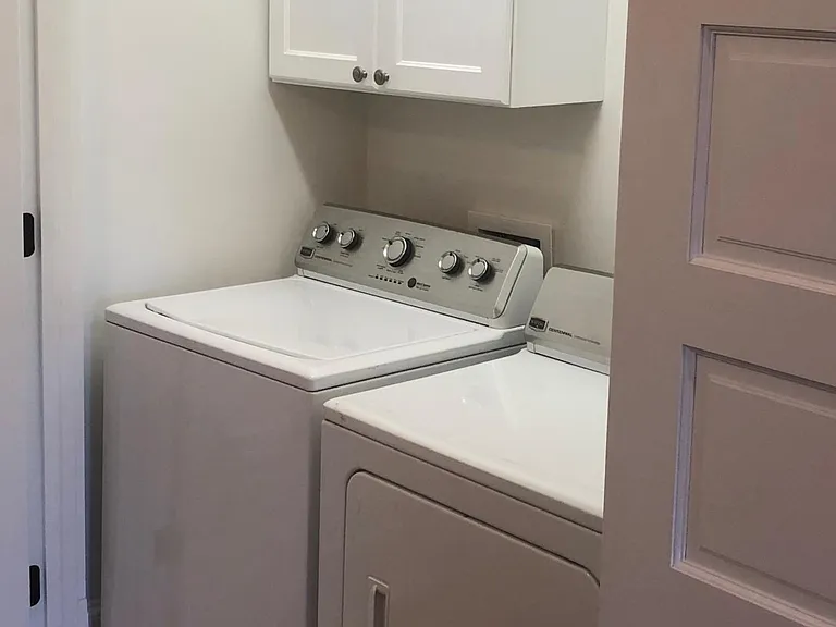 Enclosed Laundry Area with Storage and Hanging Space