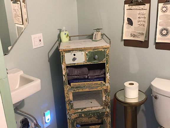 Upstairs powder room situated between bedrooms and with heated tile floor.