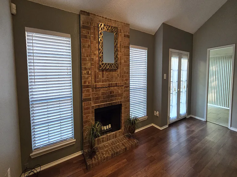 Wood Burning FIreplace With French Doors to the Side Yard