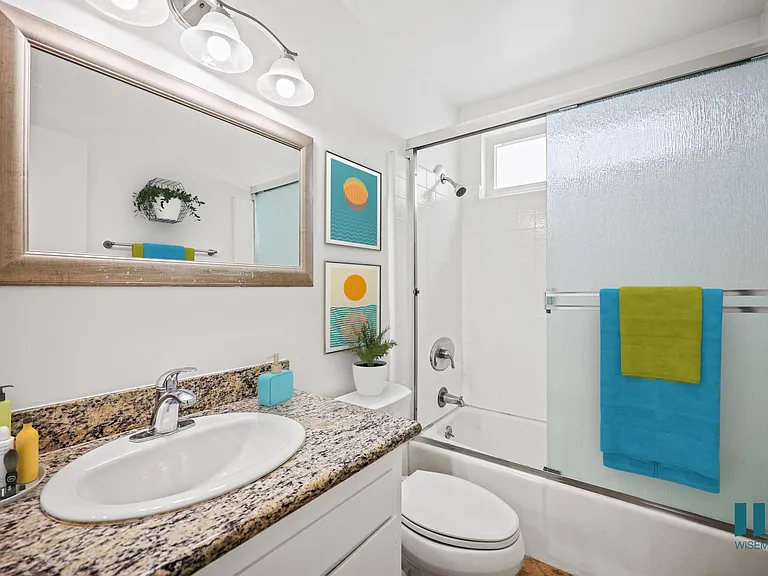 Bathroom with Shower Bath with Glass Door and Vanity Cabinet Storage