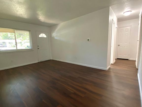 Front living room and hallway leading to 3 bedrooms