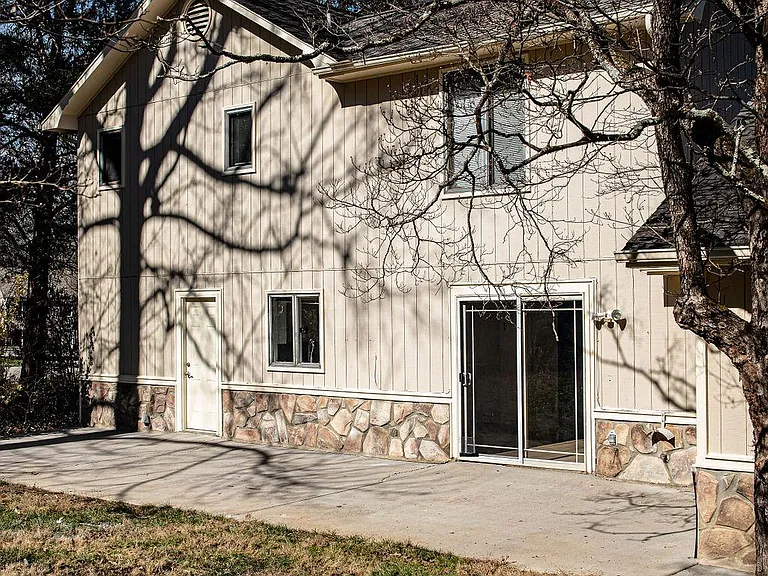 Back of home with sliding door and patio