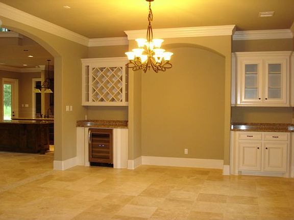 California open concept home with stone floored dining area and wine cooler.