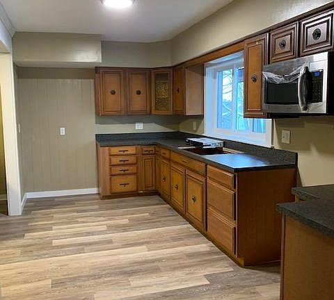 Kitchen with new side by side refrigerator with ice maker, over the range microwave and new self cleaning range. Extra large double bowl sink with sprayer, lots of cabinet space and counter top space