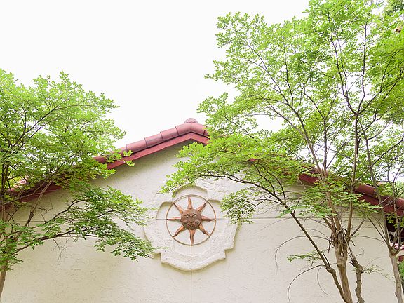 Sundial sculpture on the outside of this beautiful home.
