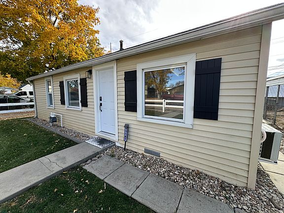 Adorable black shutters and well manicured lawn