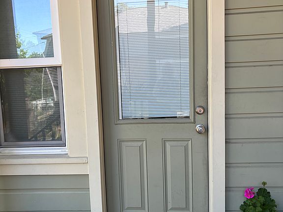 Outside of fire exit bedroom back door with motion lights outside above it . Brand new dead bolt and lock .