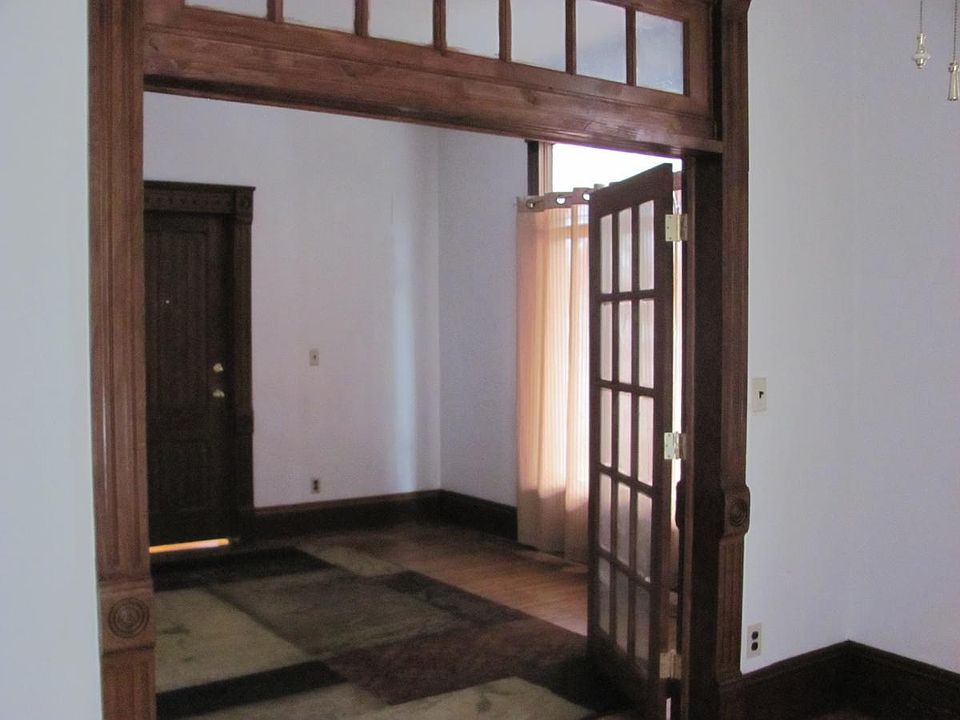 French doors divide the living room from the bedroom