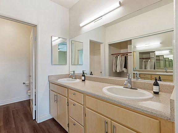 Renovated Package I bath with laminate countertops, oak cabinetry, and updated hard surface flooring