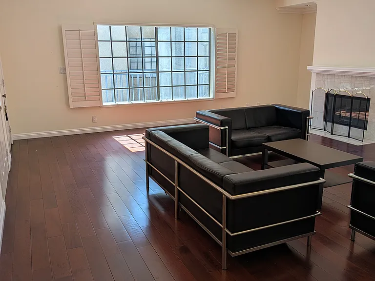 Partially furnished living room with lots of natural light