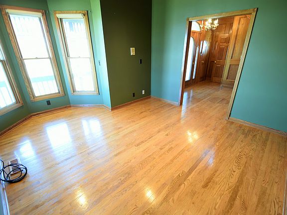 At the front of the home is the den; with large windows overlooking the wrap-around porch, this space is perfect as an office or more living space.