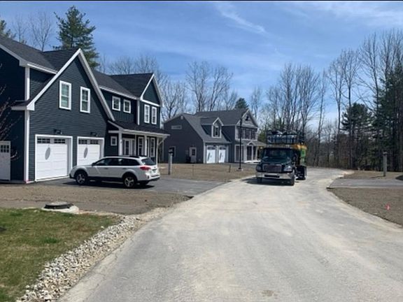 View from the street. Note that our home now has grass and the road is paved.