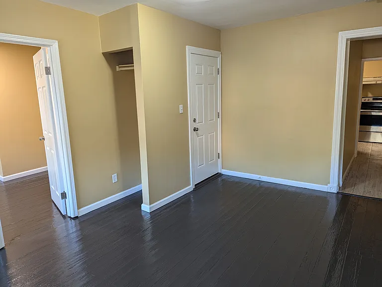 Front Door with coat closet enters into the living room. First bedroom to left and kitchen to right