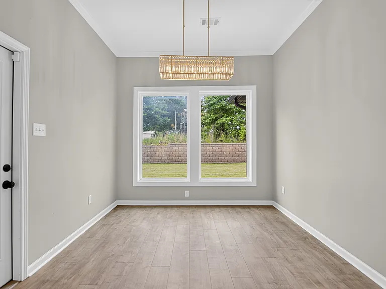 Dining area with large windows viewing the backyard.