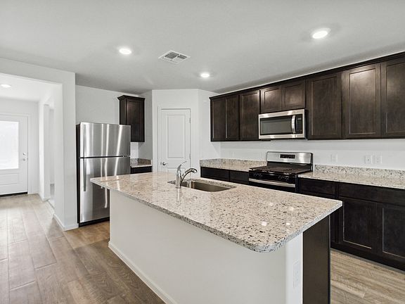 Upgraded kitchen with a large island and stainless steel appliances.