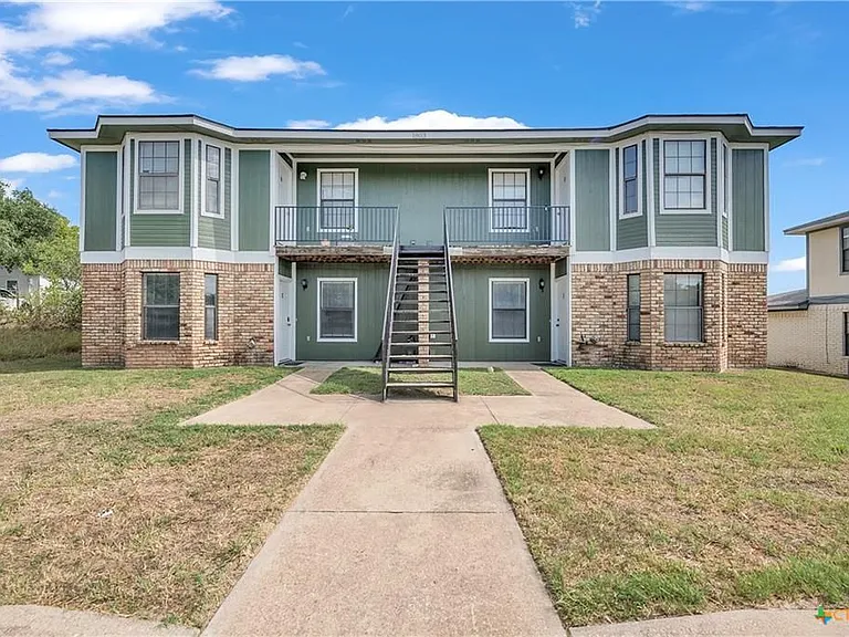 This clean-cut front yard with bi-monthly lawn-care in the summer and once a month in the winter. Unit C is the unit on the bottom left.