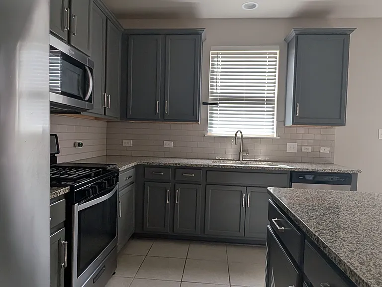 Kitchen with granite counter tops and stainless steel appliances