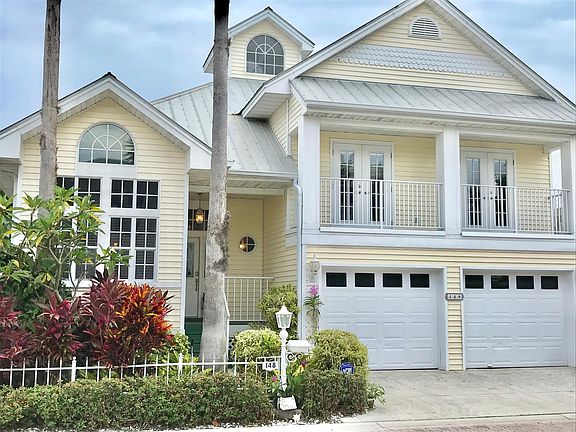 Front of home,metal roof, tropical yard all maintained for y