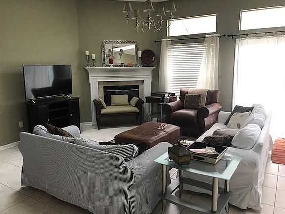 Open floor plan, skylights and cozy fireplace (wood -burning) Tile floors. Sliding door to pool enclosure.