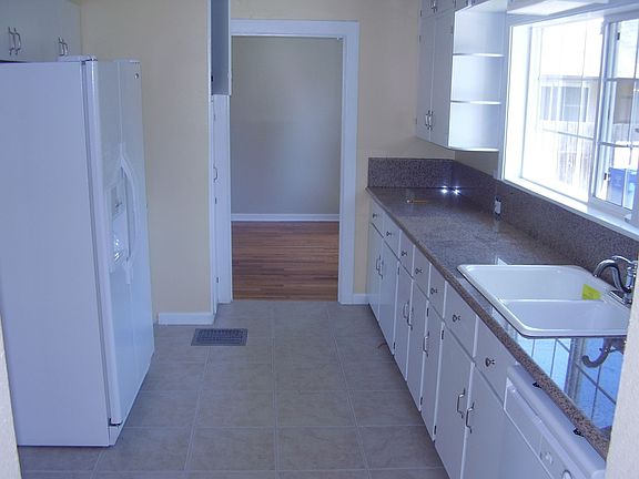 Kitchen with new fixtures, sink paint and tile flooring
