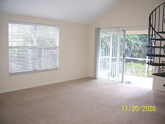 Livingroom with 8 ft. glass door opening onto tiled, screened porch.