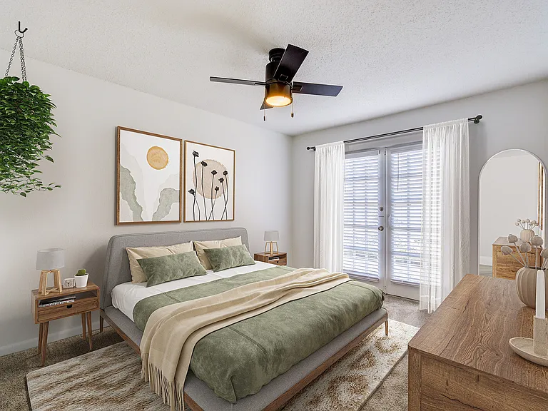 A bright bedroom is shown at ReNew on Cantrell with spacious layout and ceiling fan.
