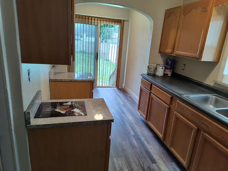 New flooring in KITCHEN with gas or electric stove hook-up, small cove with glass sliding door that leads to backyard. (Appliances available for additional $40 per month).