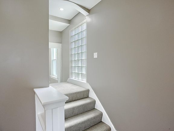 This is another shot of the steps and landing that go to the second floor or over to the kitchen.