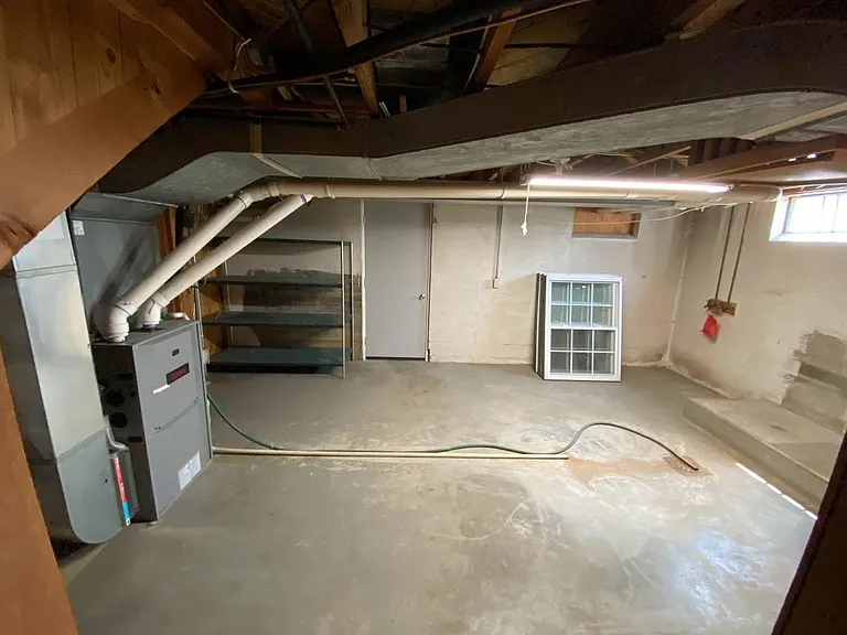 Basement laundry room with washer dryer hookups. Door leads to the tuck under garage