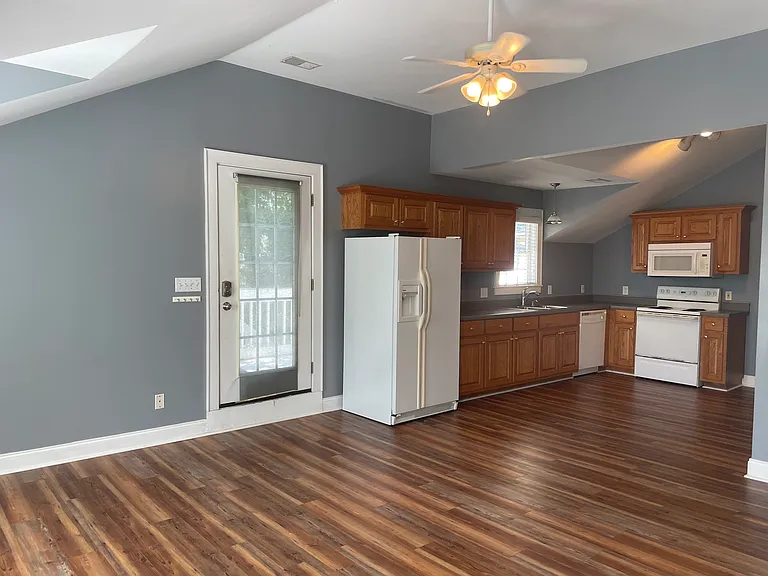 Cool LVP flooring and high ceilings help make this space truly special