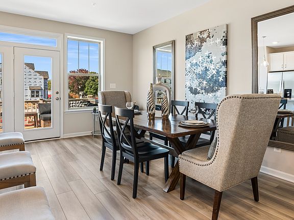 Open dining area adjacent kitchen at a DRB Homes Upton II model home at the Canterbury Station com
