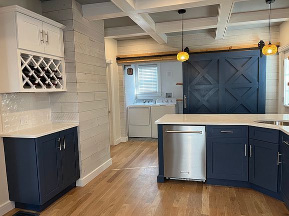Kitchen with a view of the Laundry Room. The over-sized custom Gliding Barn-door allows access to the Laundry Room.