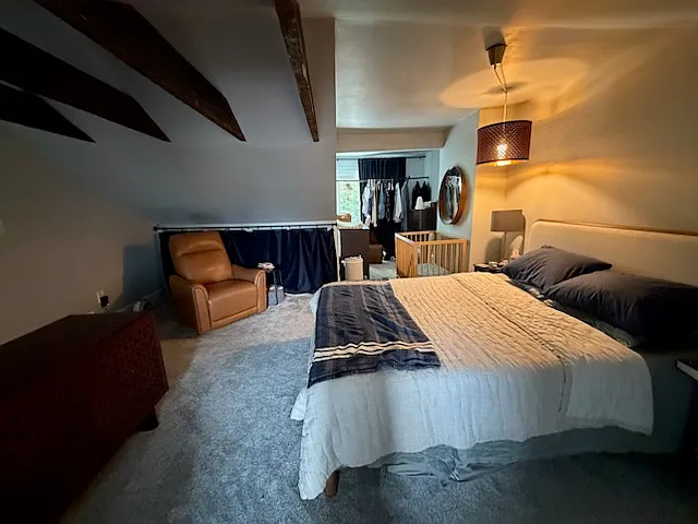 Third-floor media/flex space (currently shown with a bed for scale). Please note: Due to Pittsburgh egress window codes, this space does not qualify as a legal bedroom and is leased strictly as a bonus room/studio.