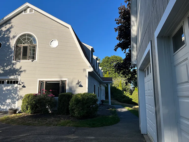 Free parking space in detached covered garage with sidewalk to front entrance. Ring camera and motion lights provide safety features.